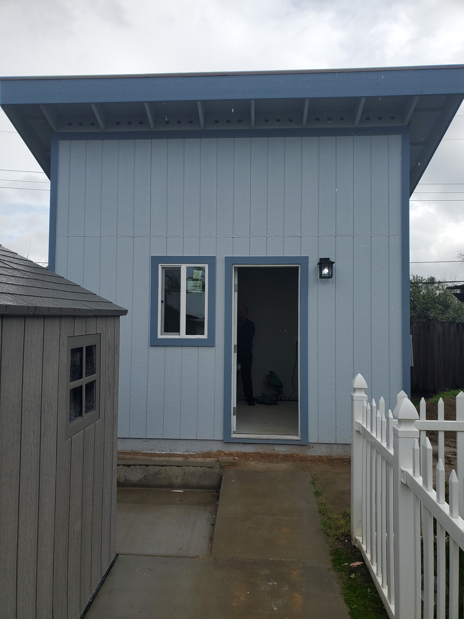 Finished accessory structure with siding and windows