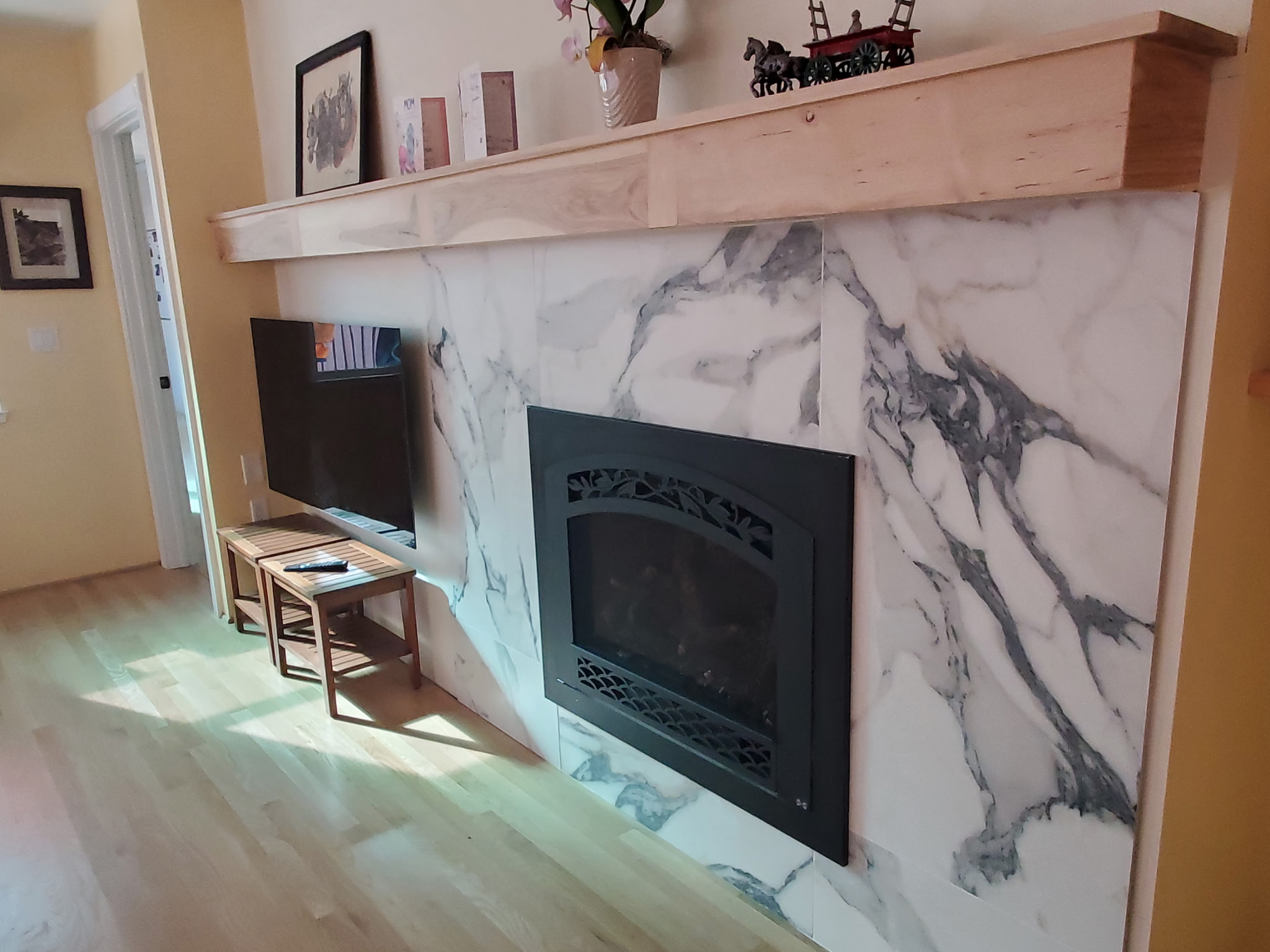 Fireplace remodel with marble surround and custom wood mantel