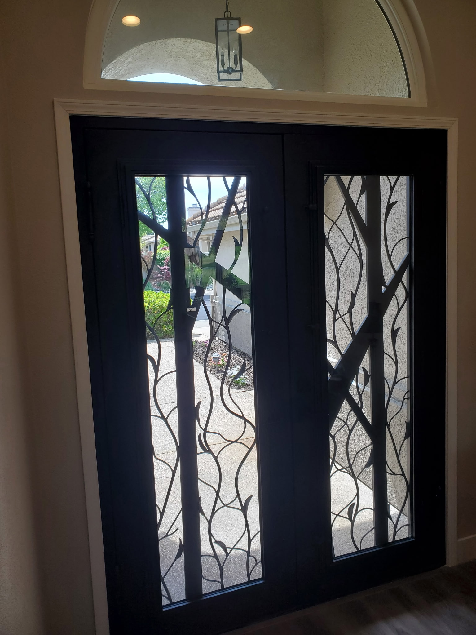 Custom decorative iron front door installation